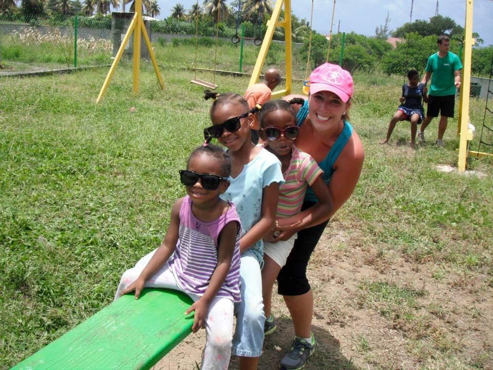 Trinity medical school student playing on a playground with children