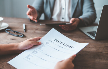 Closeup of an interviewee holding up a resume during a medical school admissions interview