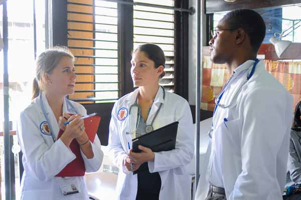 Trinity medical school students standing in a circle and talking