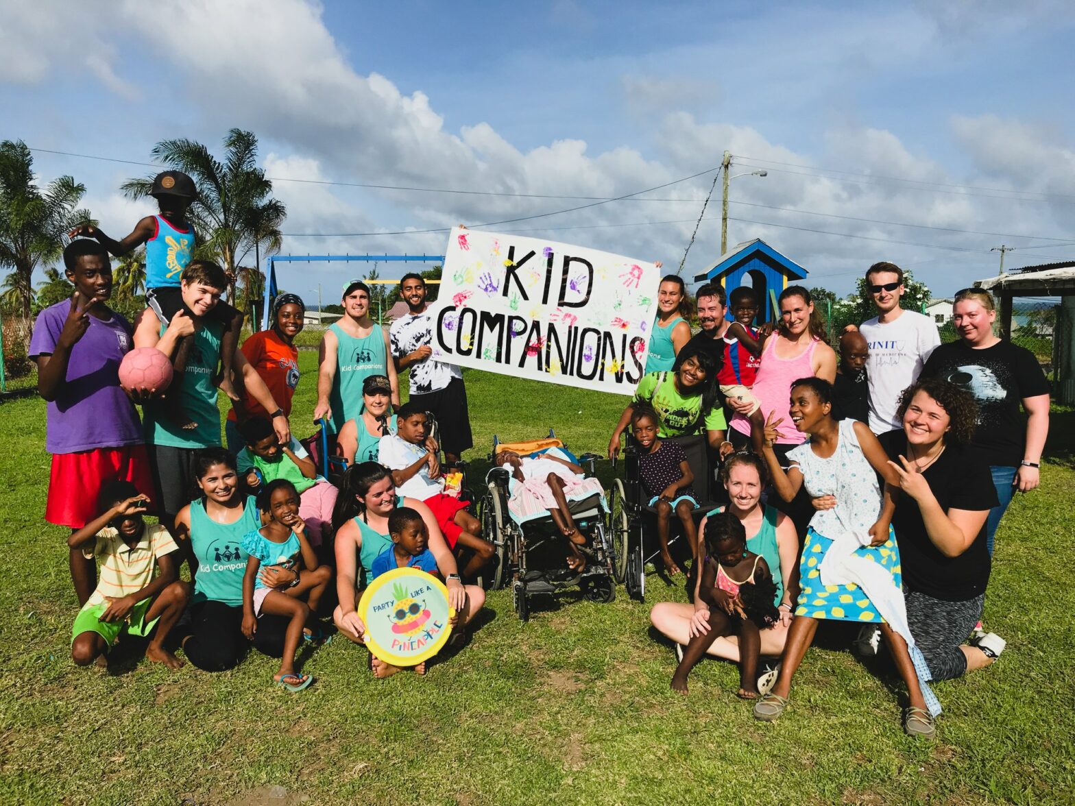 Group photo of Trinity medical school students with children at a local orphanage