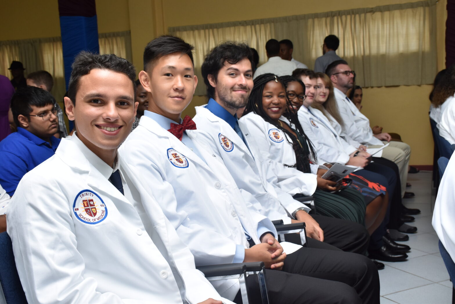 Trinity medical school students sitting ina line at 2019 White Coat Ceremony