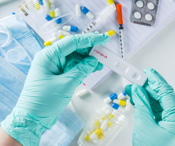 Closeup of a doctor looking at a covid test in hands