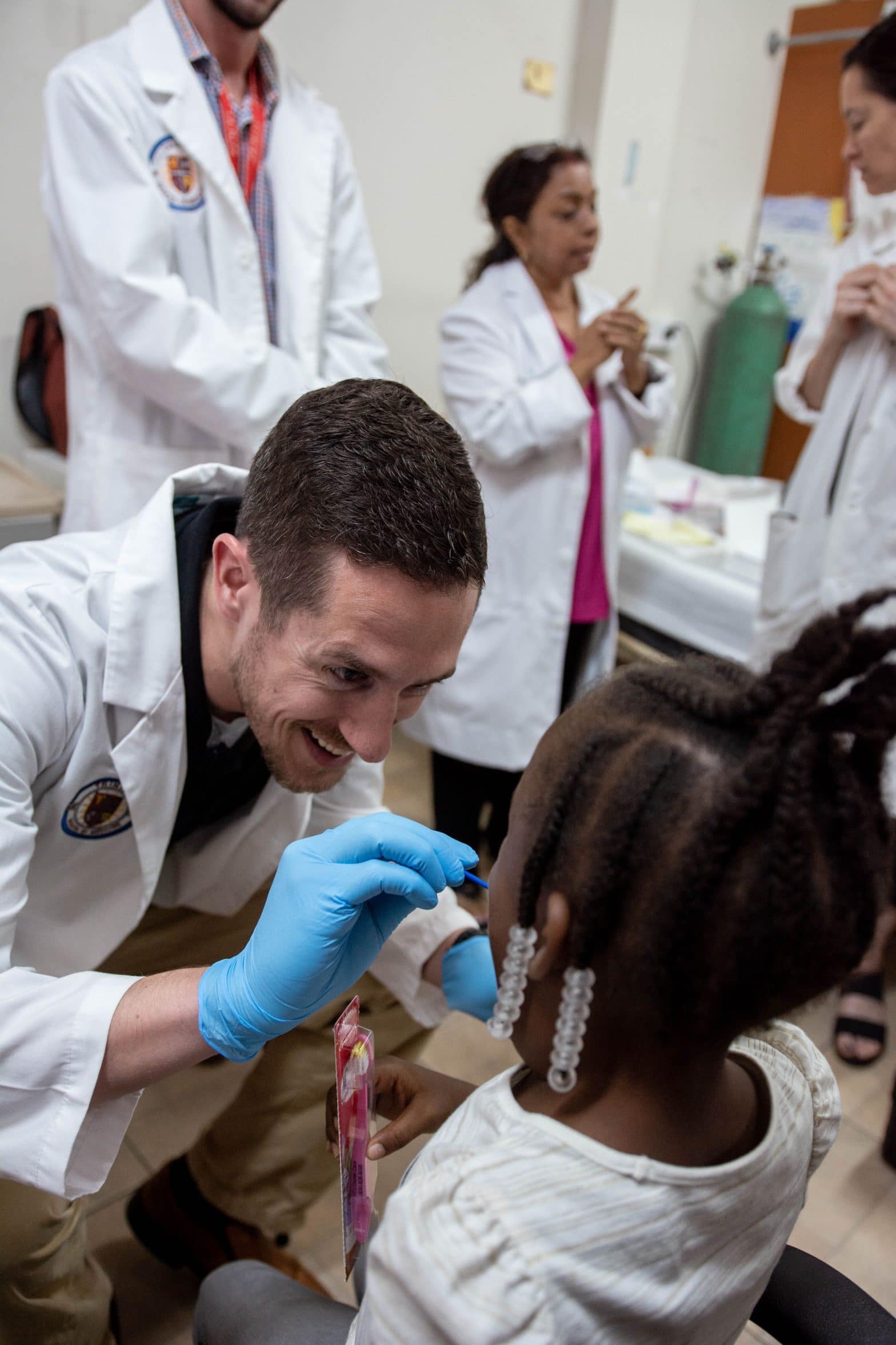 Trinity student practicing medical experience with a child during a clinical