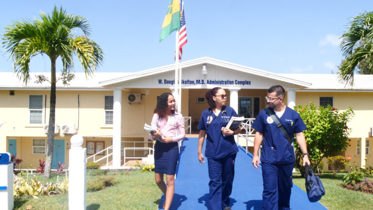 Medical school faculty walking in front of the Administration Complex