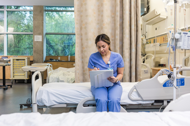 Medical student takes notes during clinical rotation