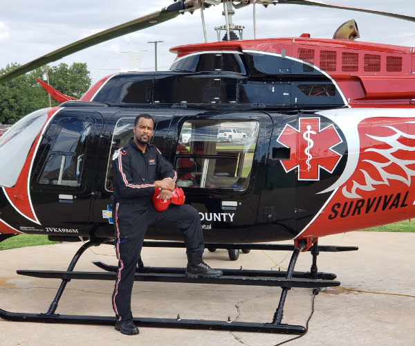 Gregory Proctor posing by a medic helicopter