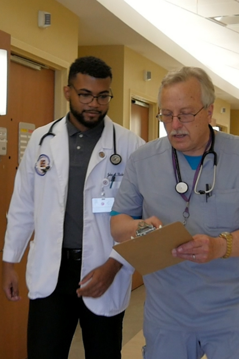 Student and doctor walking in the hallways at an accredited Caribbean medical school