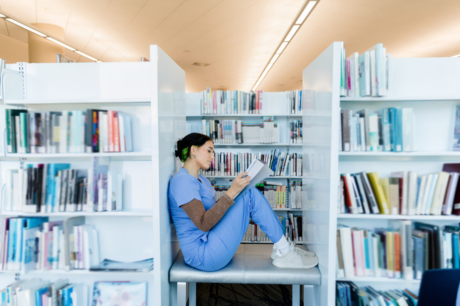 happy student studying in the library after transferring medical schools