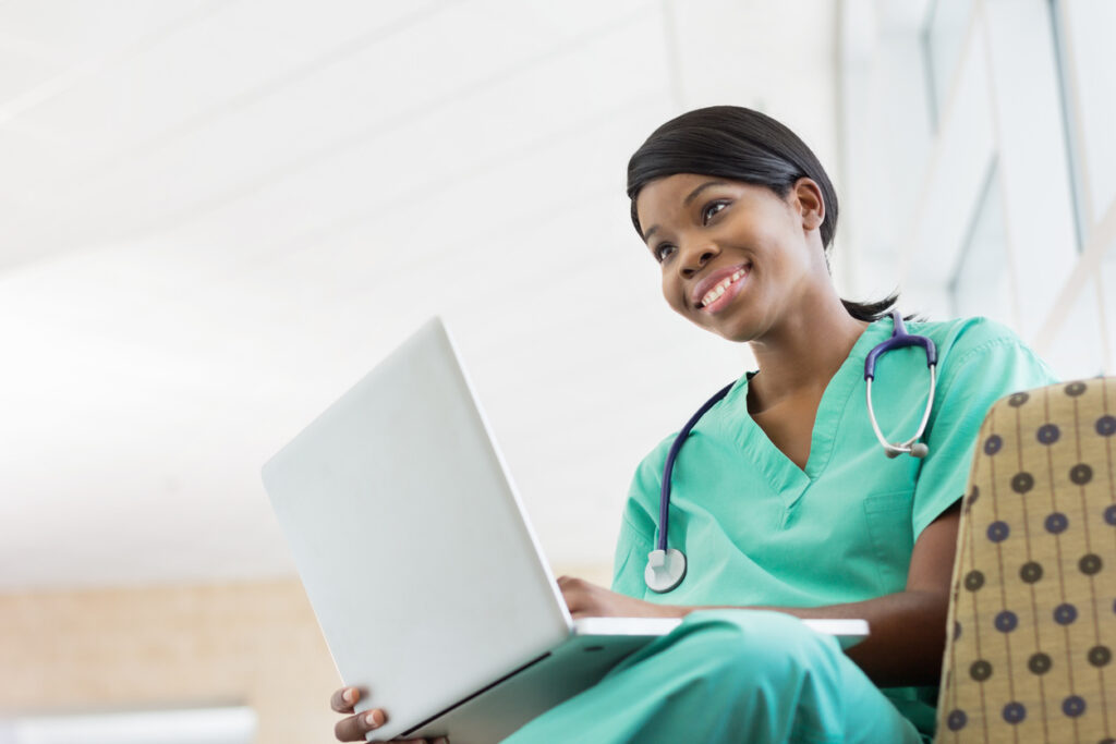 female student studying pre-med abroad while sitting with her laptom